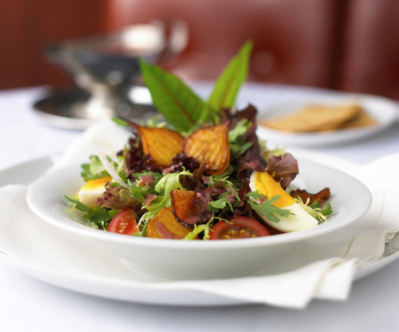 Salad served at the fine dining steakhouse, Chops Grille. Best cruise vacation restaurant dining served table side.