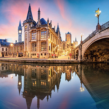 Explore the charm of Europe with historic canals and illuminated streets in Ghent, Belgium