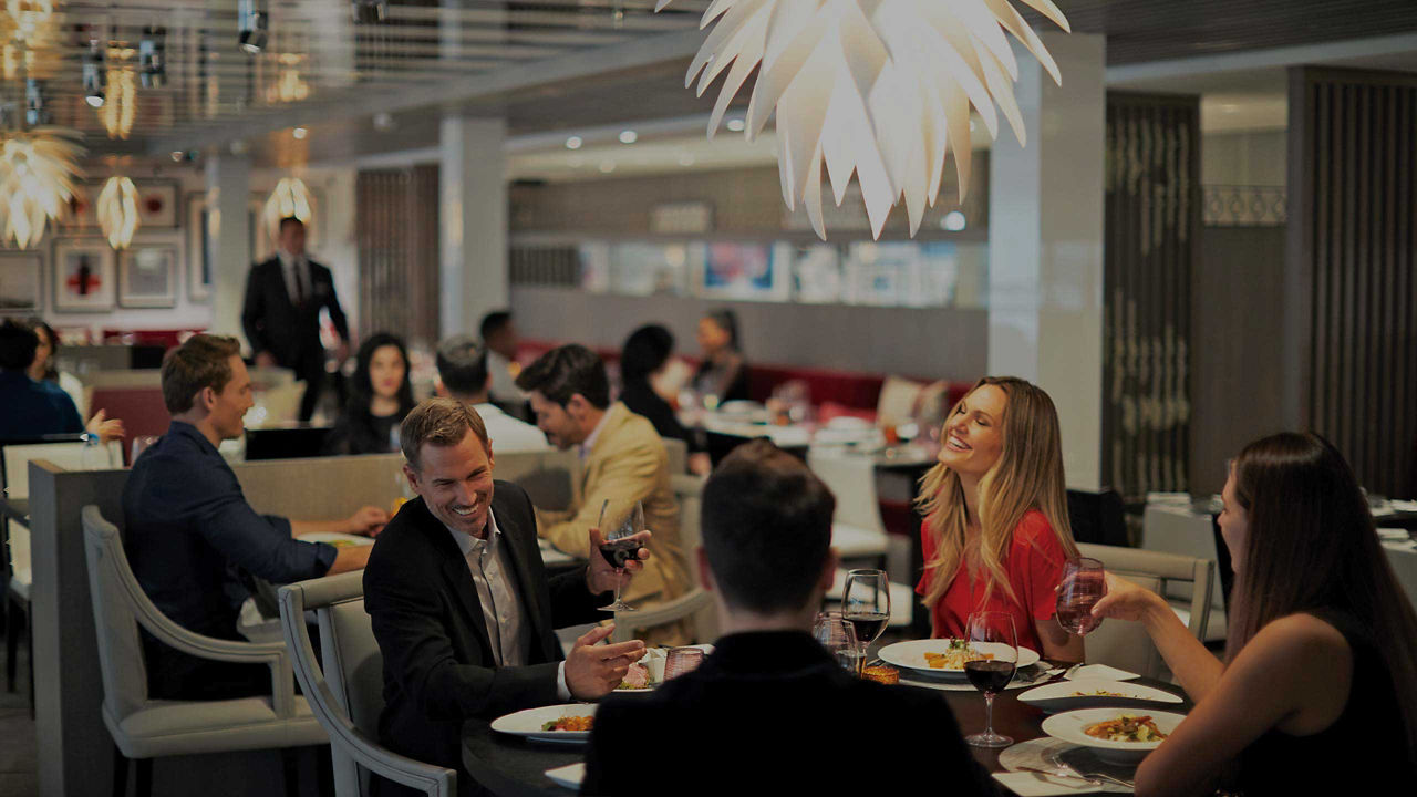 A fine dining restaurant decorated in glowing whites and twinkling lights.