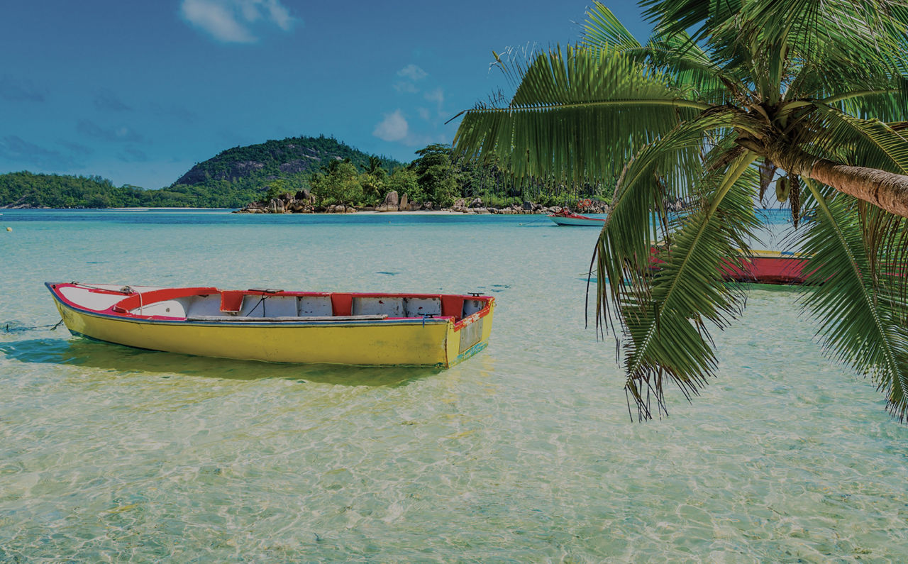 Caribbean beach with floating small boats near shore