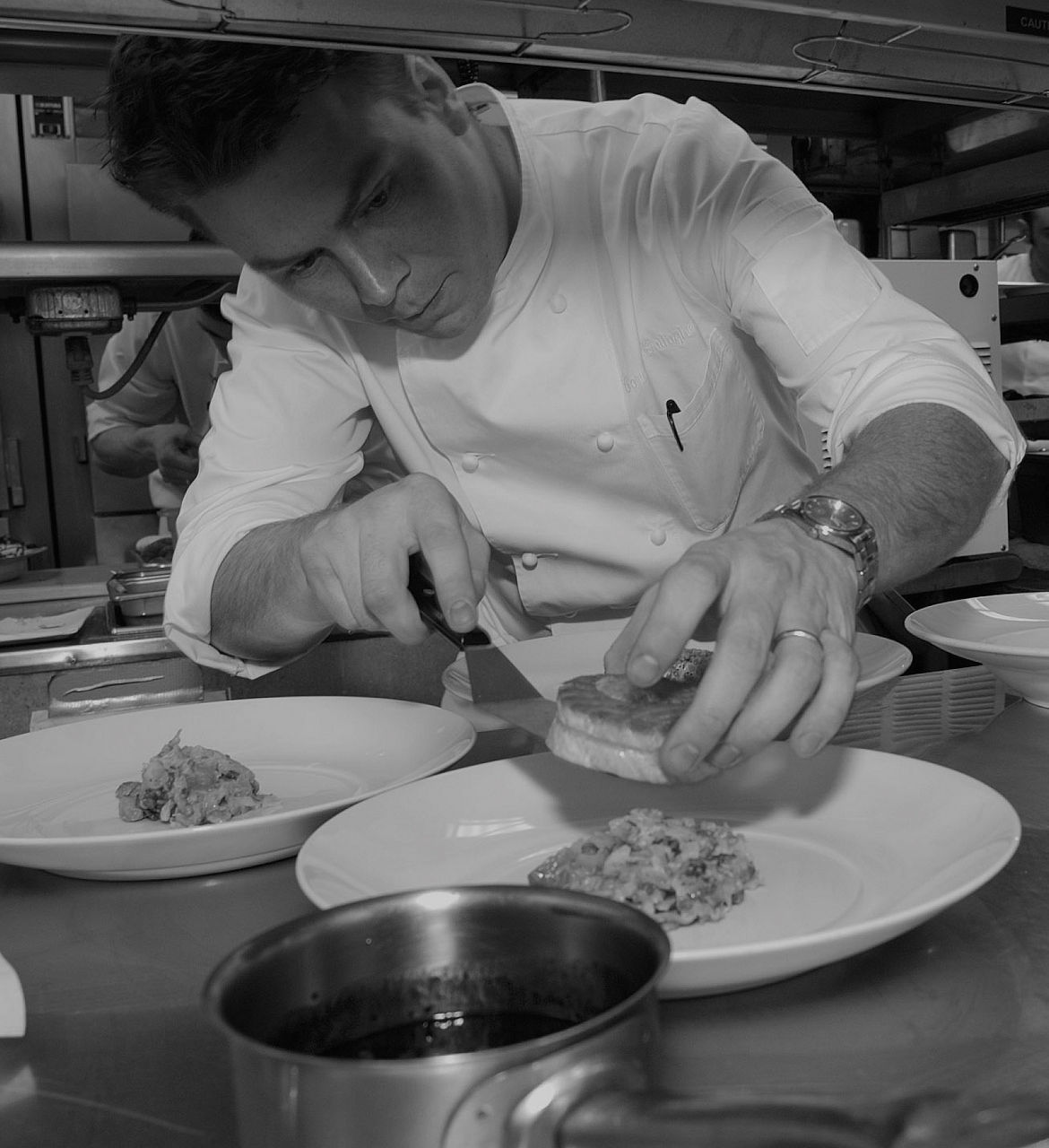 Chef cooking and dressing a plate