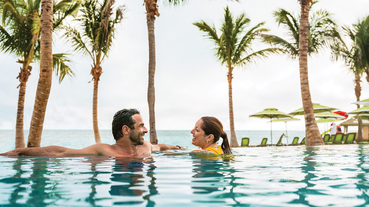 couple swimming in the infinity pool