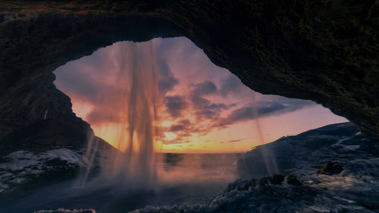 view behind the Seljalandsfoss waterfall in Iceland