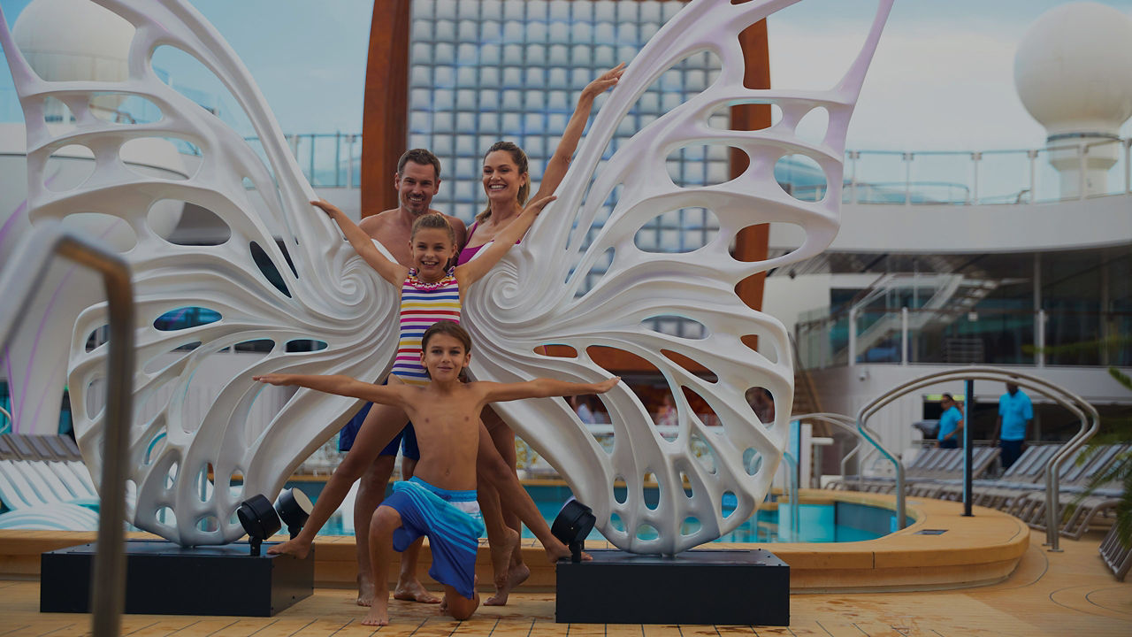 family enjoy a swim and relaxation on a modern pool deck complete with plush lounge chairs