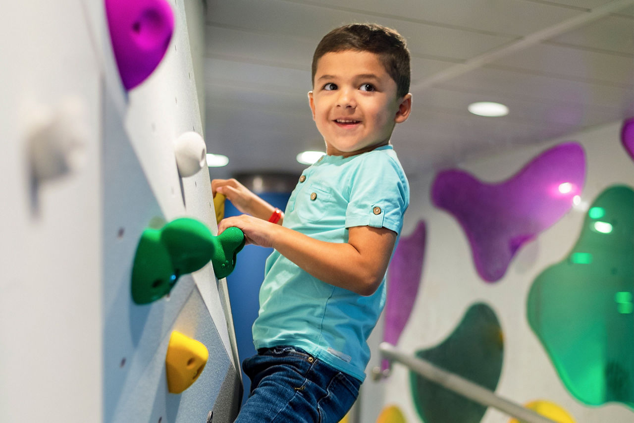 Boy Climbing the Rock Wall at Adventure Ocean 