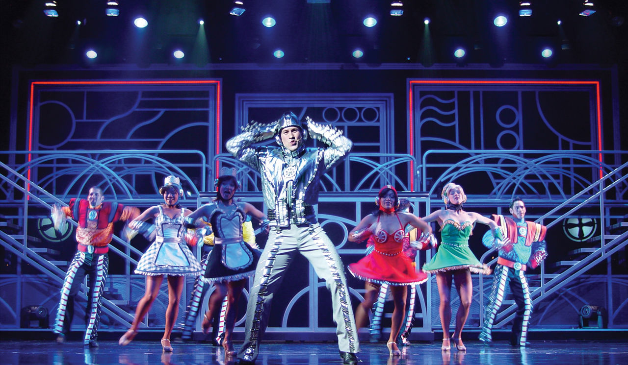 Performers dresses in costumes on stage during the West End to Broadway Cruise Show on Jewel of the Seas