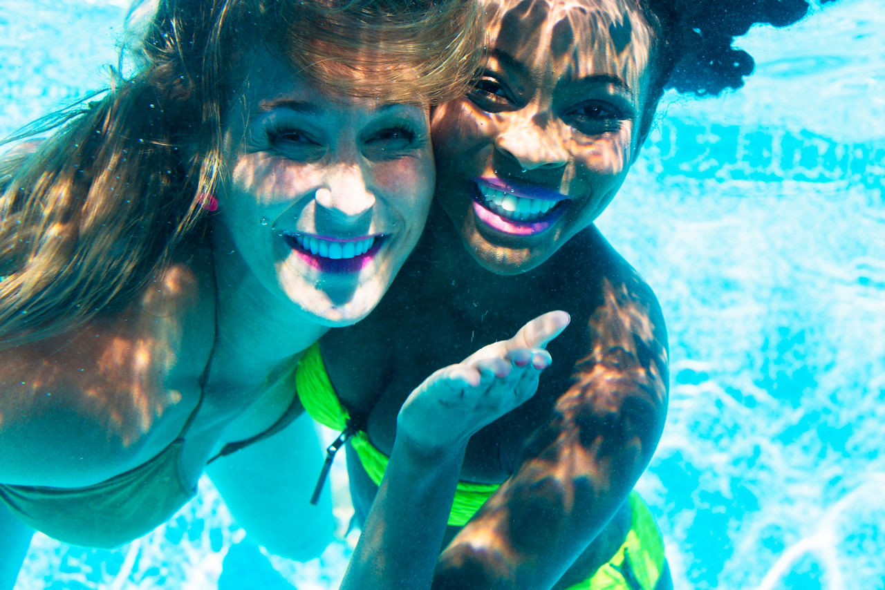 Friends Diving in The Pool