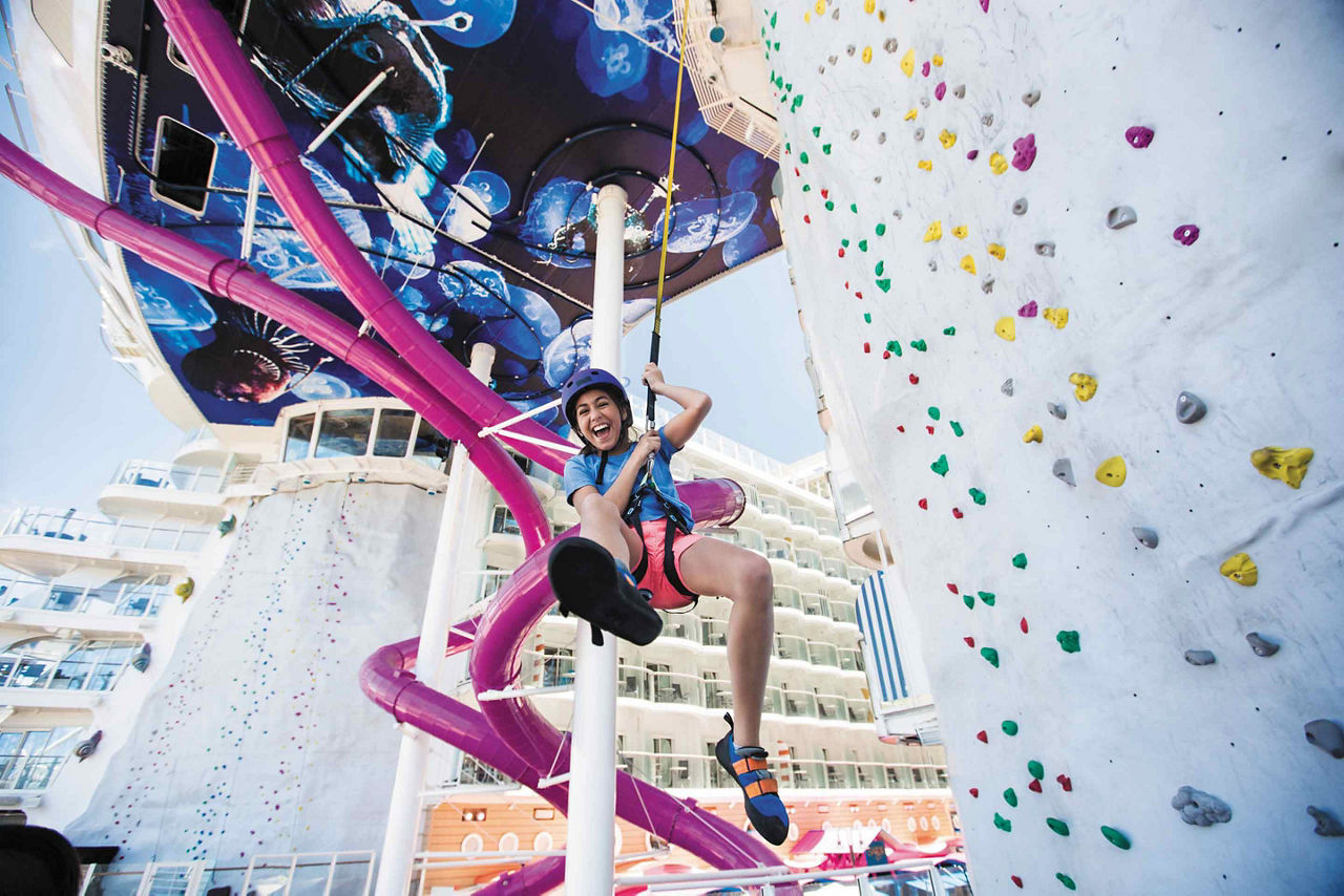 Girl Finishing the Rock Climbing Wall