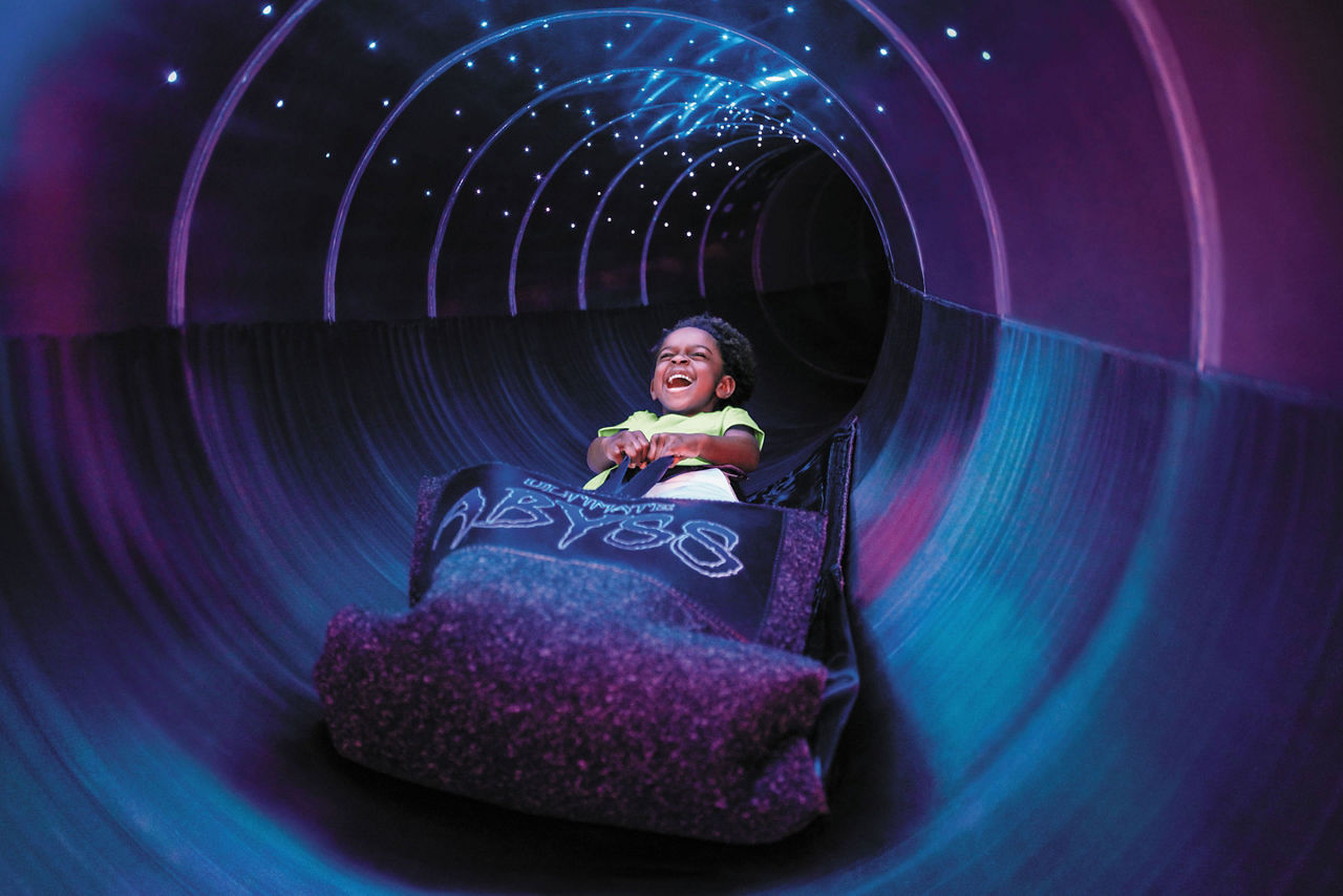 A child yelling while going down the Ultimate Abyss