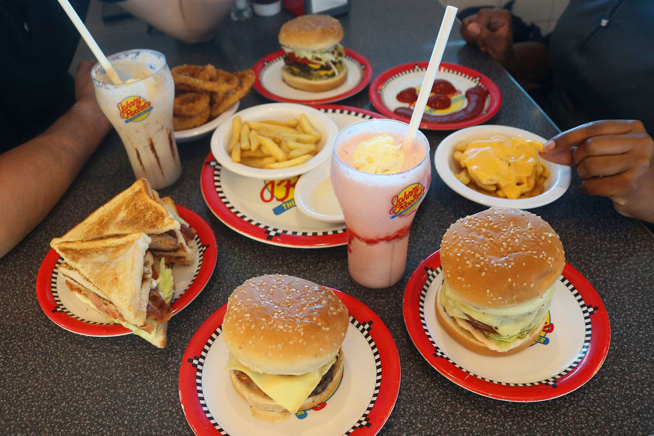Friends Enjoying Hamburgers, Melts and French Fries