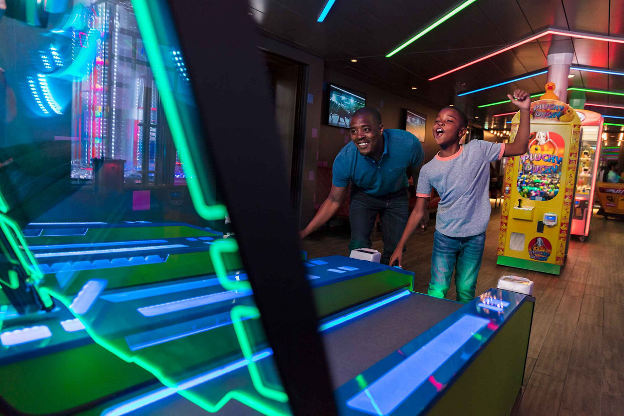 Father and son playing skee ball at the arcade 