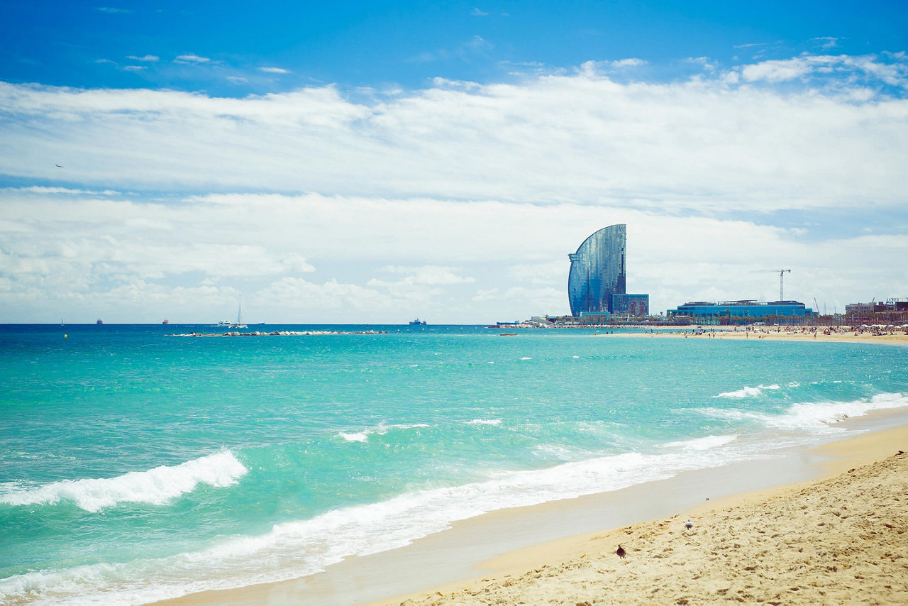 Barceloneta Beach at sunset, with a view of the W Hotel in Barcelona, Spain
