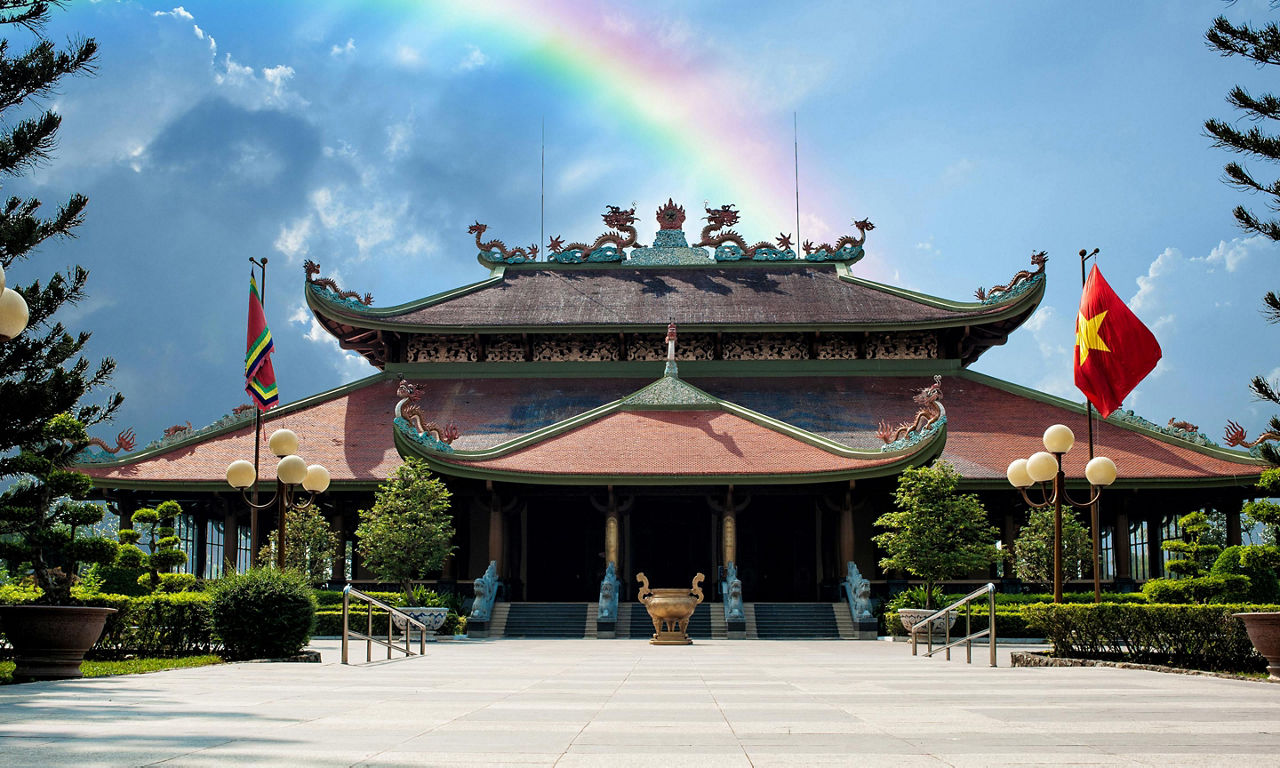 Historical Ben Duoc Temple entrance with a rainbow shining over it in Ho Chi Minh, Vietnam