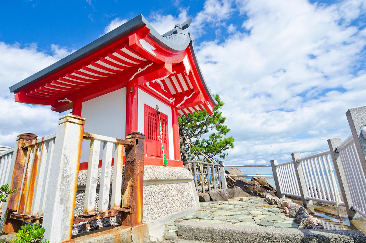 A small red shrine on the point of Katsurahama beach in Kochi, Japan