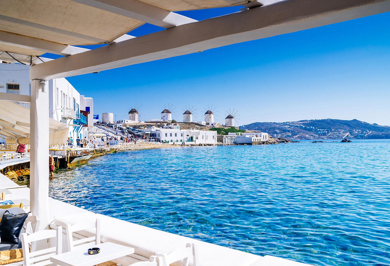 View of the famous Mykonos windmills as seen from a restaurant in Mykonos, Greece