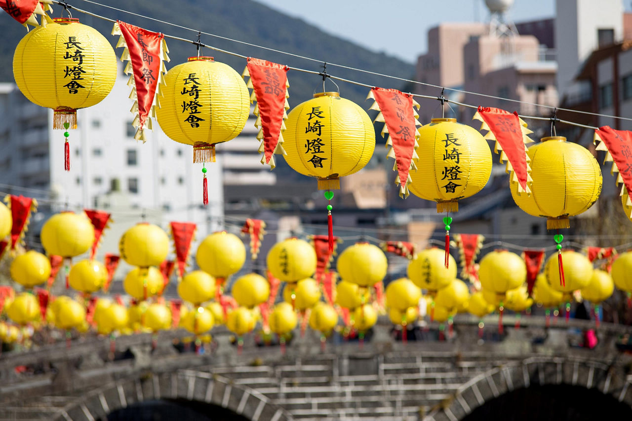 Yellow lanterns lined up along the Megane bashi, or glass bridge, in Nagasaki, Japan