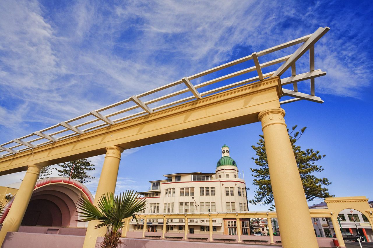 A sawtooth roof-line of an old white industrial building in Napier, New Zealand