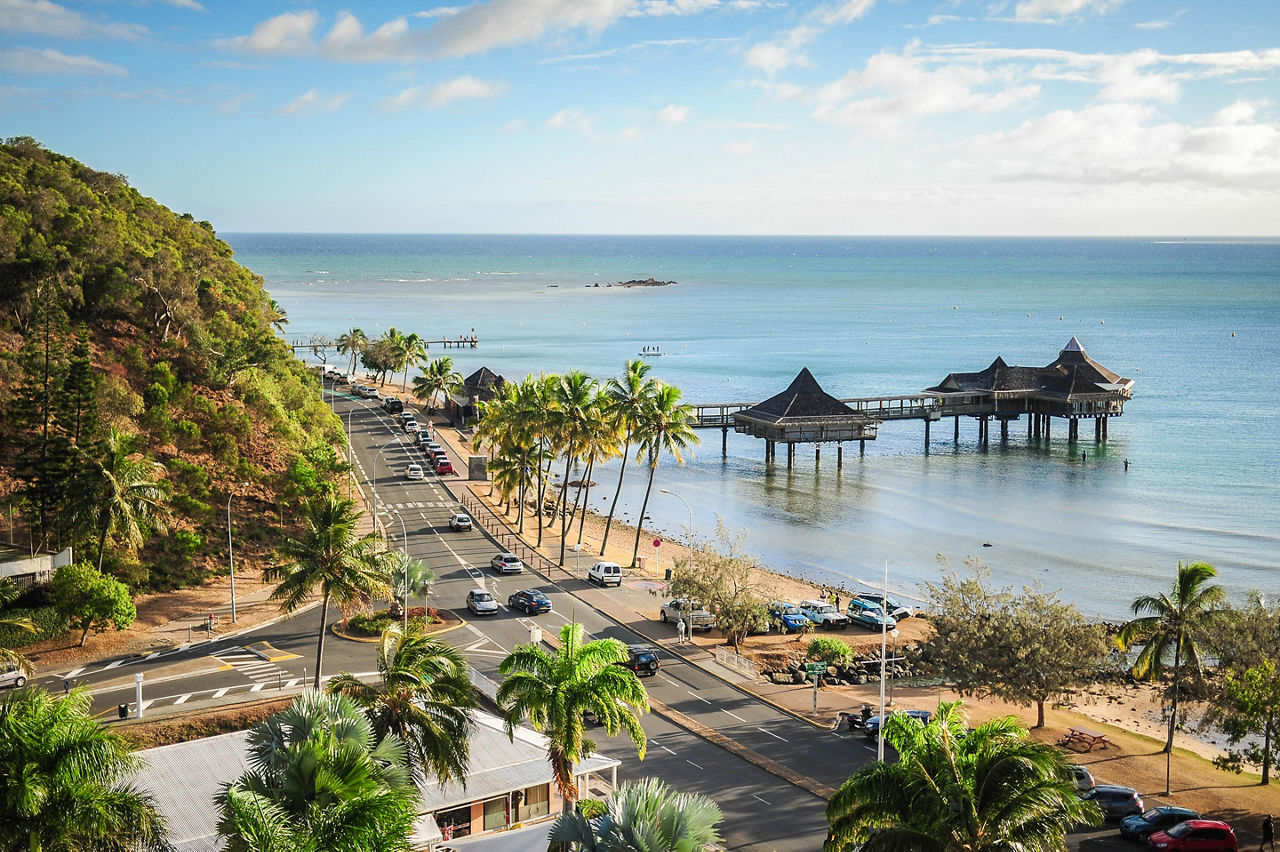 Views of Noumea's streets and city along the beaches with tikis over the water