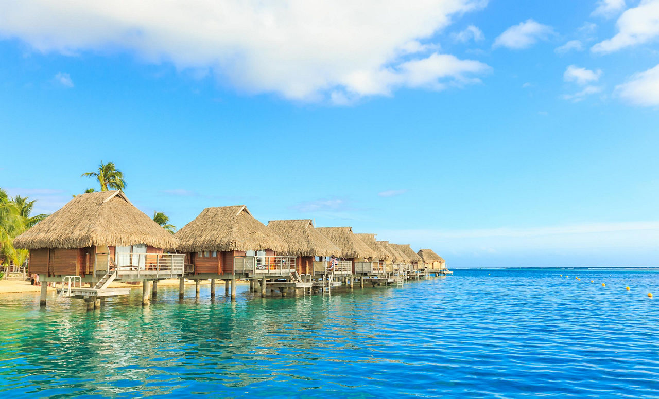 Over the water tiki huts in a beautiful resort in Papeete, Tahiti