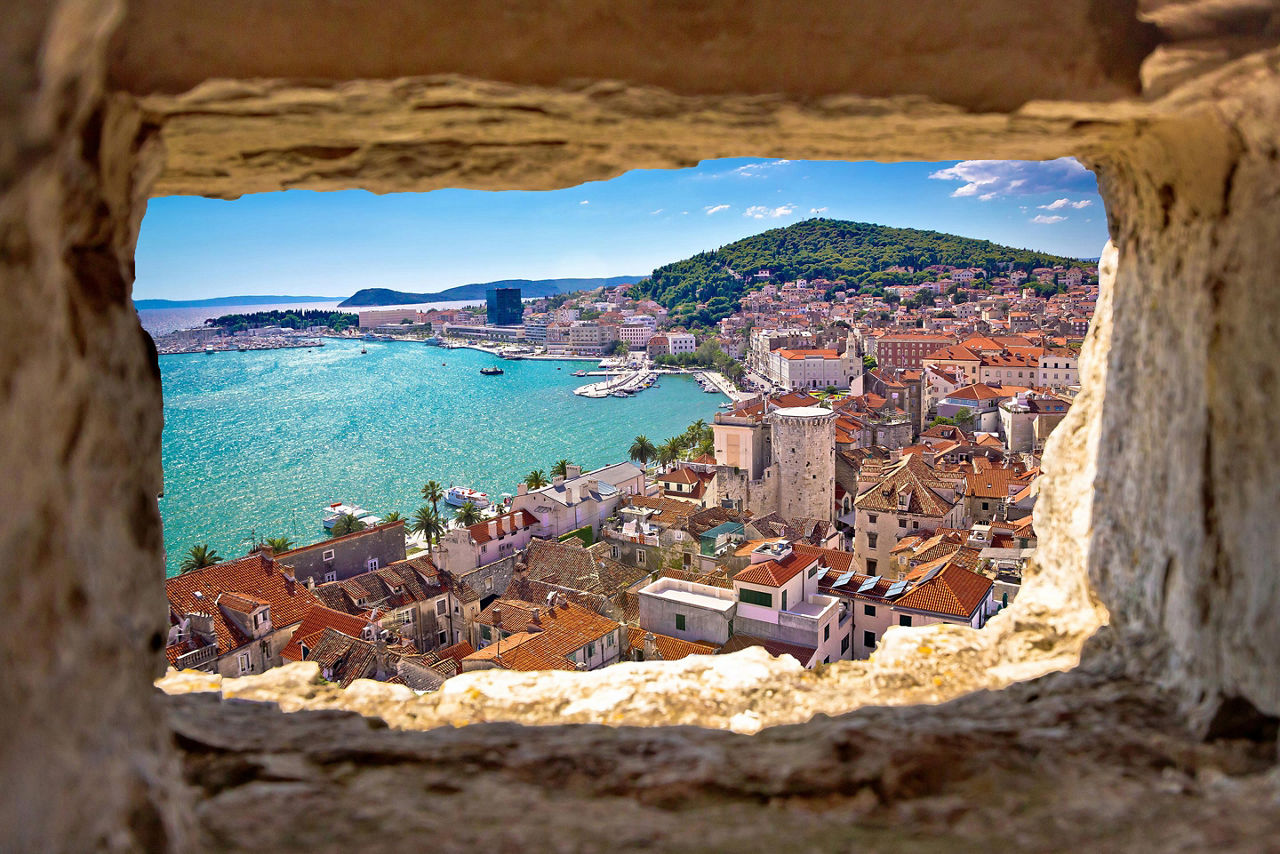 Beautiful high view of Split bay area through a stone window in Split, Croatia