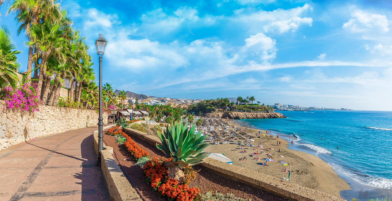 A beachfront walking path at El Duque beach in Tenerife, Canary Islands