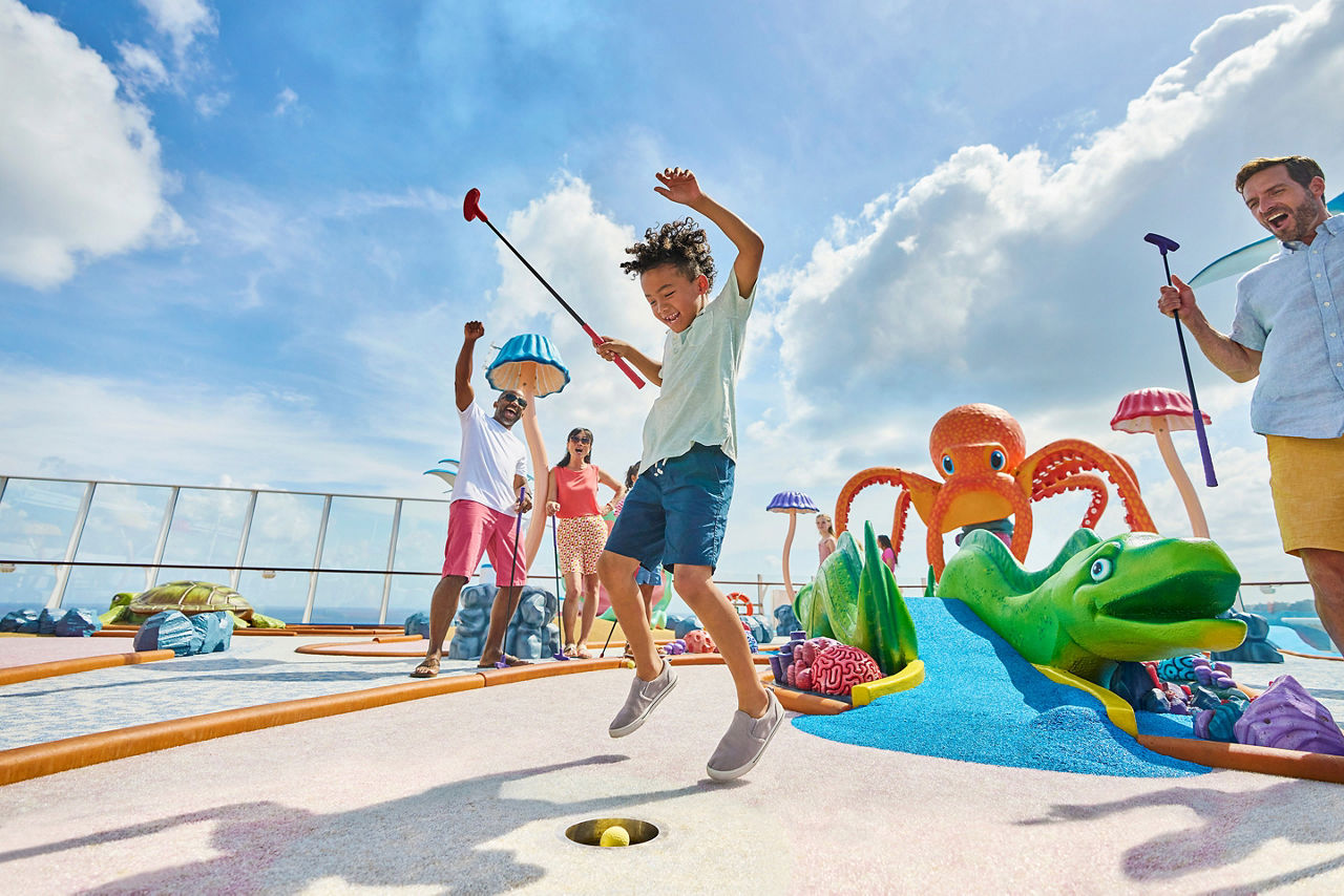 utopia of the seas perfect day kids with parents playing golf at wonder dunes
