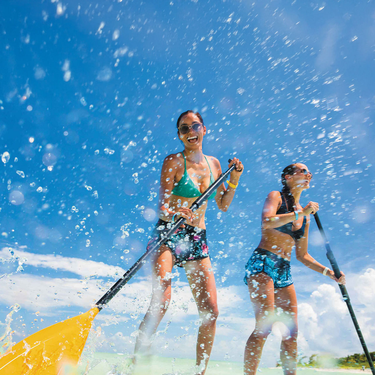 Two Girls Having Fun Paddle-boarding, Cozumel, Mexico