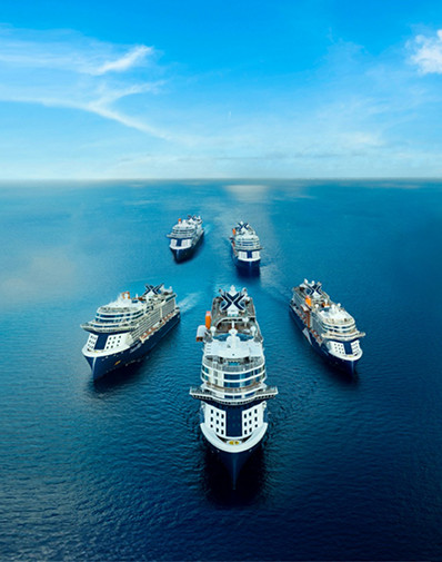 Five Celebrity cruise ships sailing in formation across the ocean