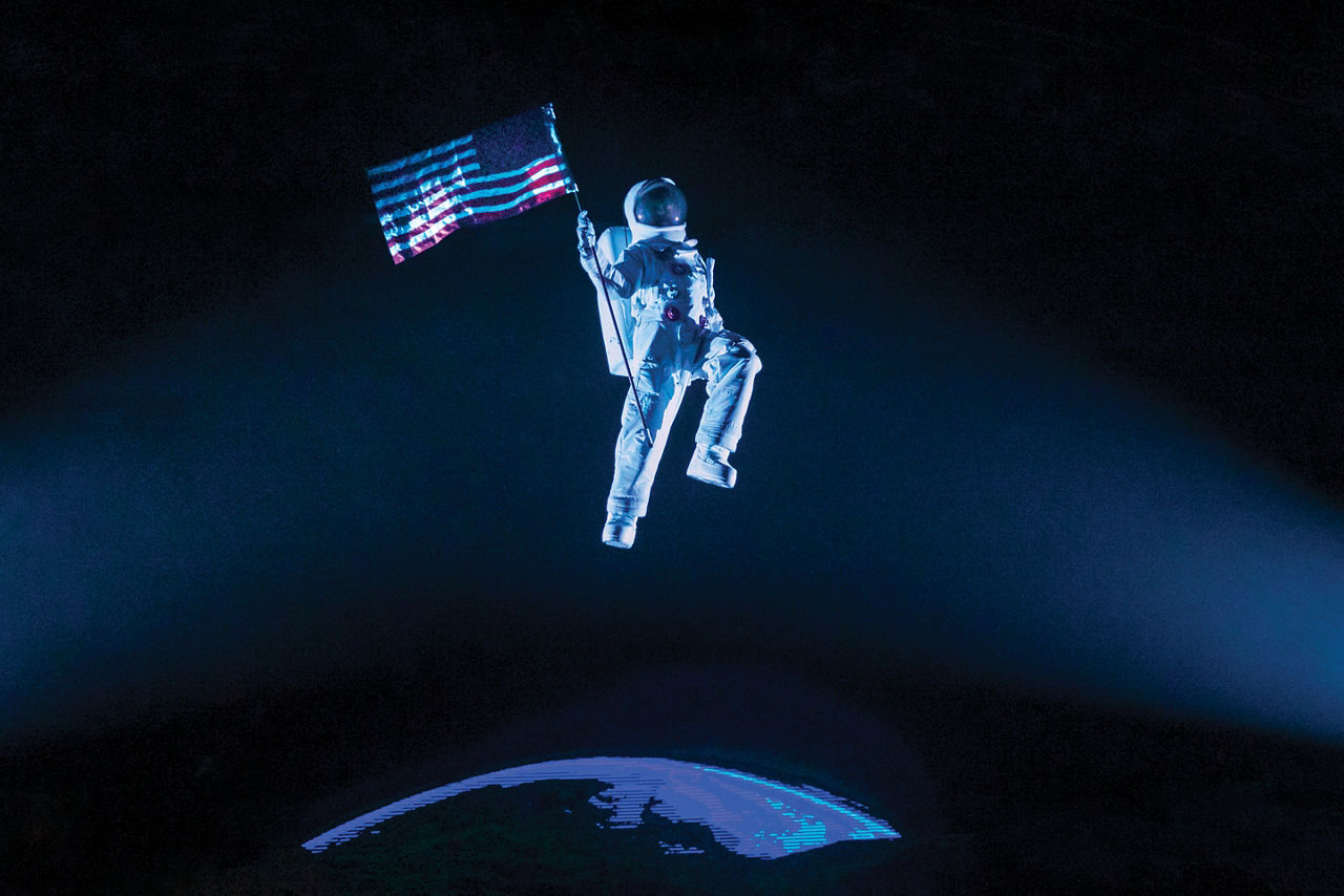 Astronaut Holding the American Flag in the Royal Promenade Theatre During Flight