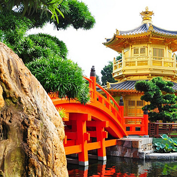 A red bridge leading to a temple Chinese architecture in a garden in Hong Kong, China