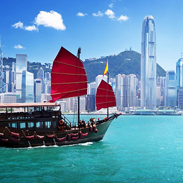 Traditional Boat with Skyscraper in the Background 