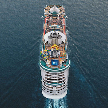 Drone shot aerial view of the cruise ship Independence of the Seas as it sails out straight into the sea
