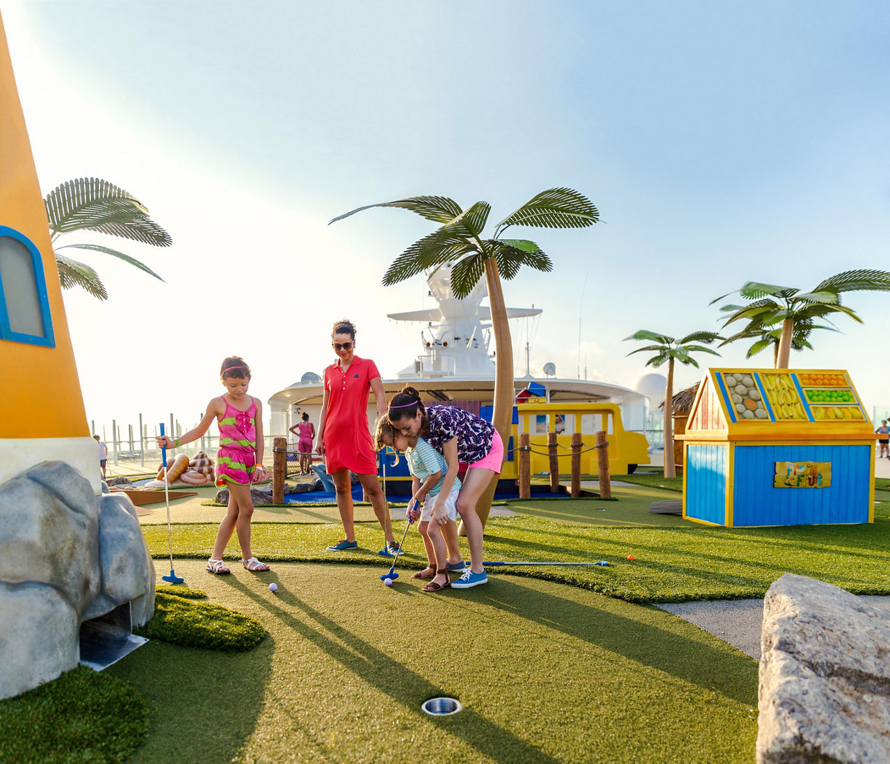Family Enjoying a Round of Mini Golf 