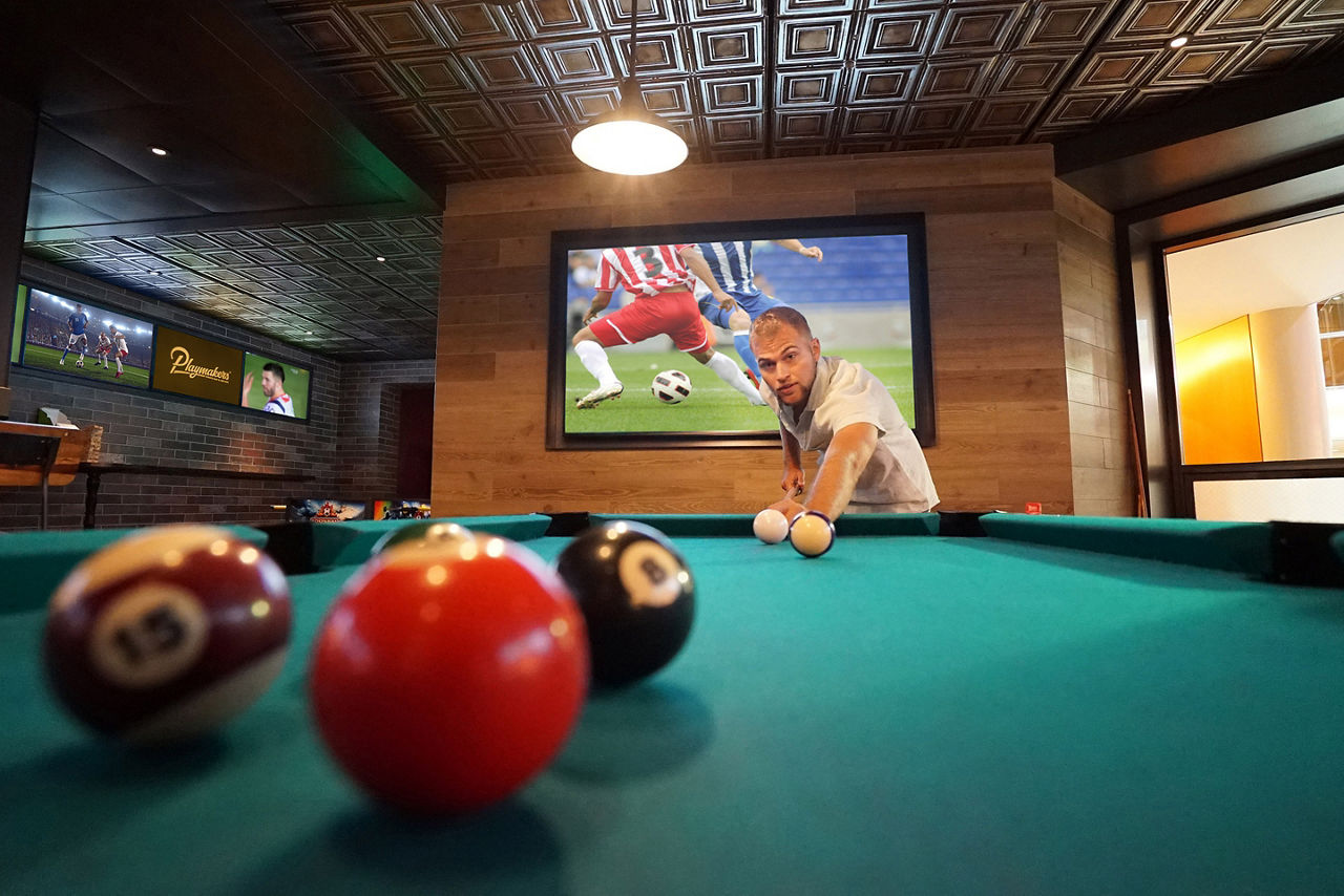 Man Playing Pool at Playmakers