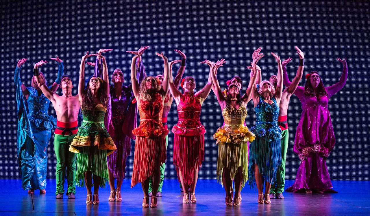 Performers dresses in colorful costumes on stage during the Sonic Odyssey Cruise Show by Royal Caribbean