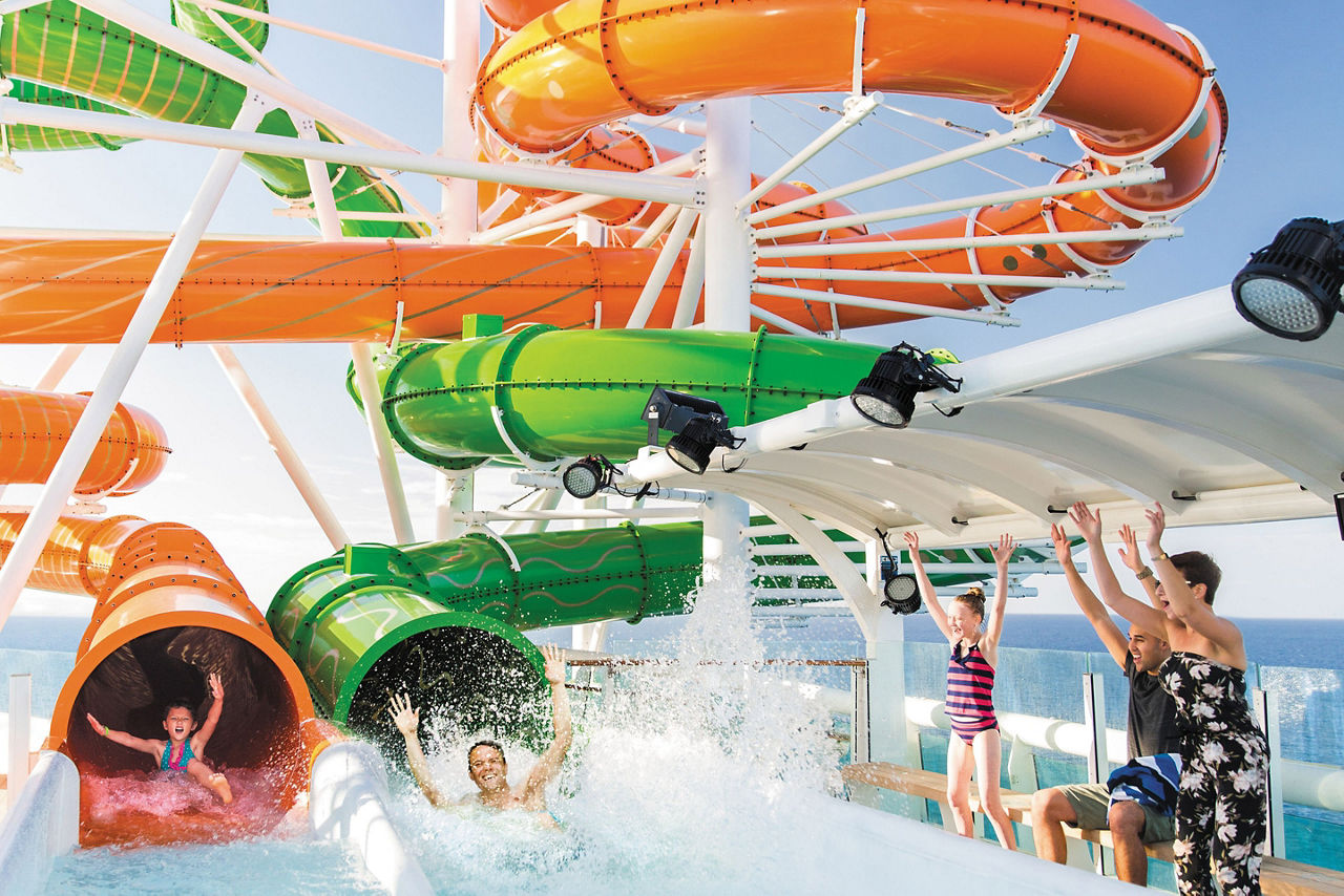 Adult and kid enjoying slides of Perfect Storm
