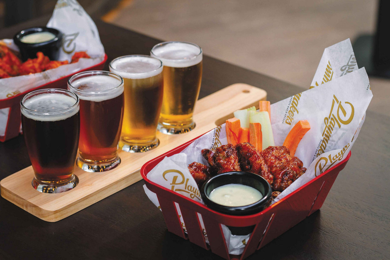 Chicken wings and beer served at Playmakers Sports Bar & Arcade 