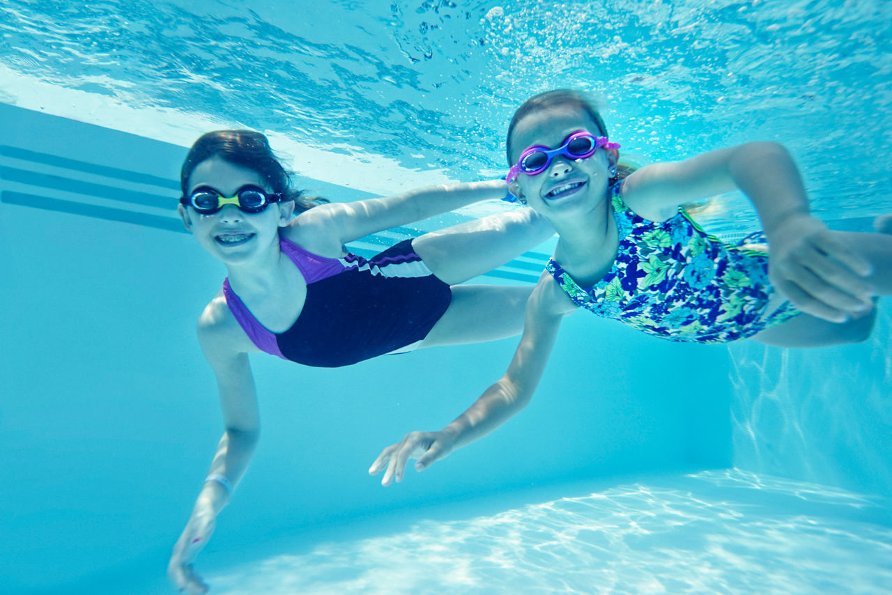 Girls Diving and Swimming in the Covered Pool 