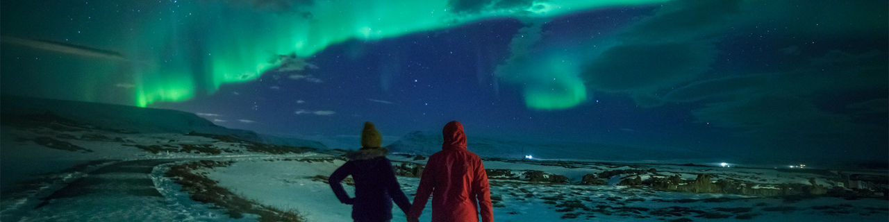 Couple watching Northern Lights in Alaska