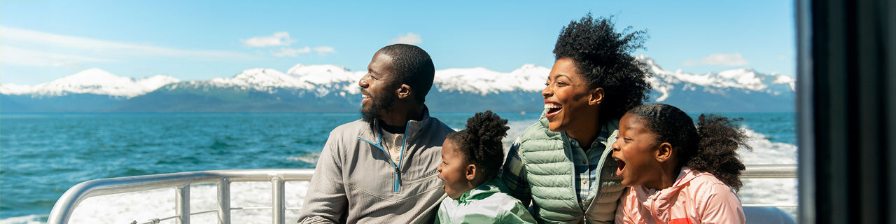Family watching out for whales on an Alaskan Cruise