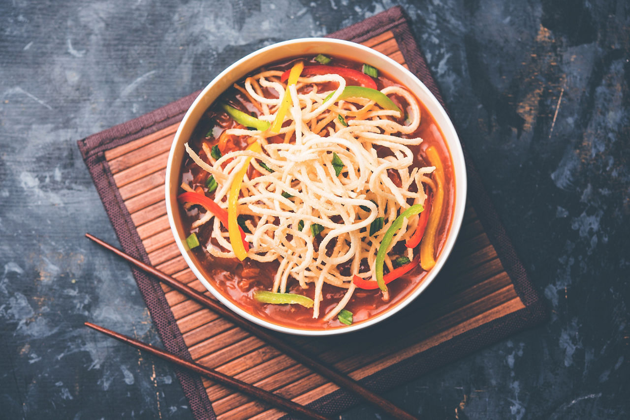 American chop suey served in a bowl with chop sticks