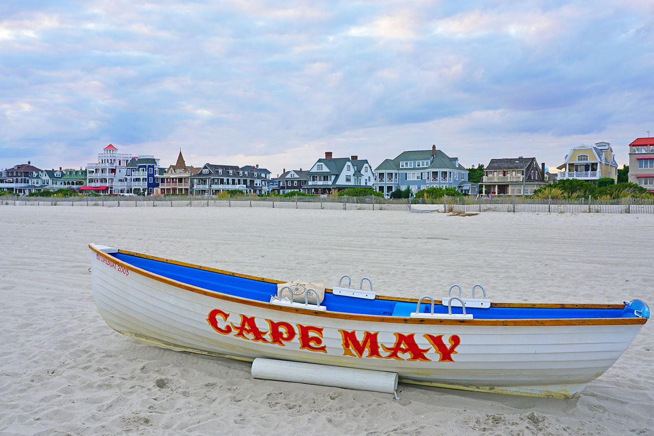 View of a boat with a Cape May sign on the beach in Cape May, New Jersey, USA.