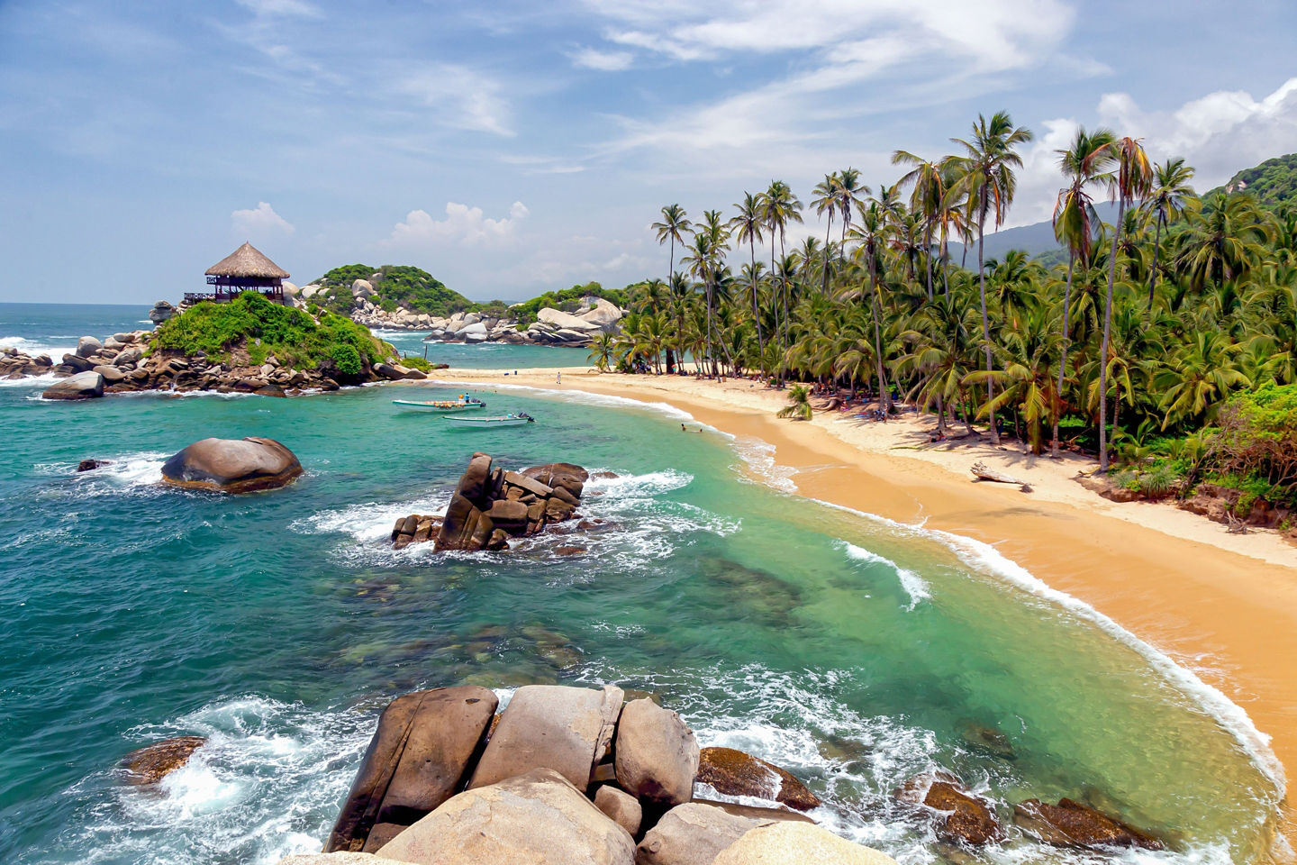 Palm‑lined cove surrounds turquoise waters at Tayrona’s Cabo San Juan. - Cartagena, Colombia