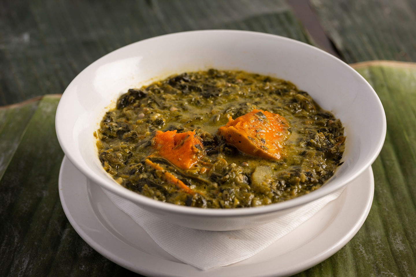 A bowl of Trinidadian callaloo soup shows rich green broth with tender vegetables and herbs. - St. Croix, U.S. Virgin Islands