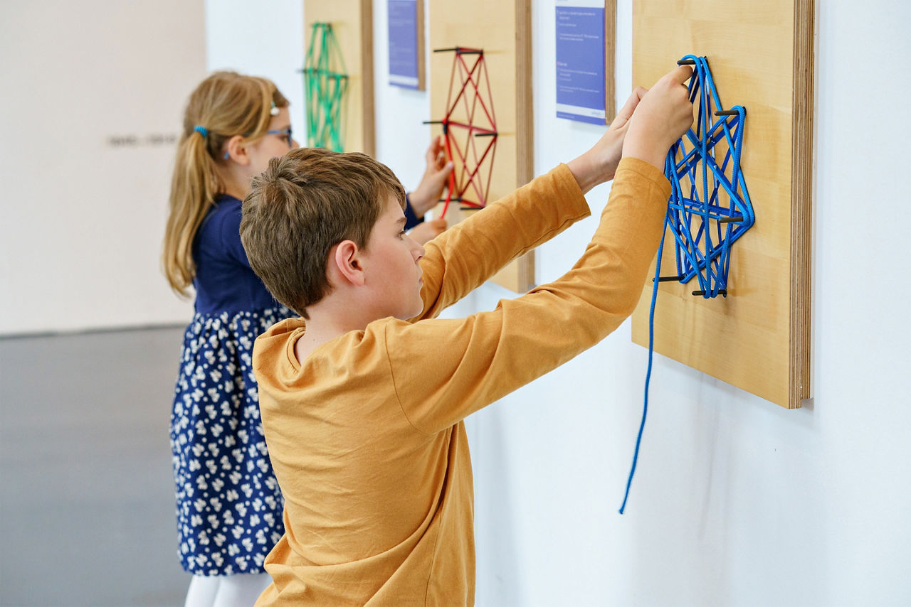 children having fun with building and creating geometric figures