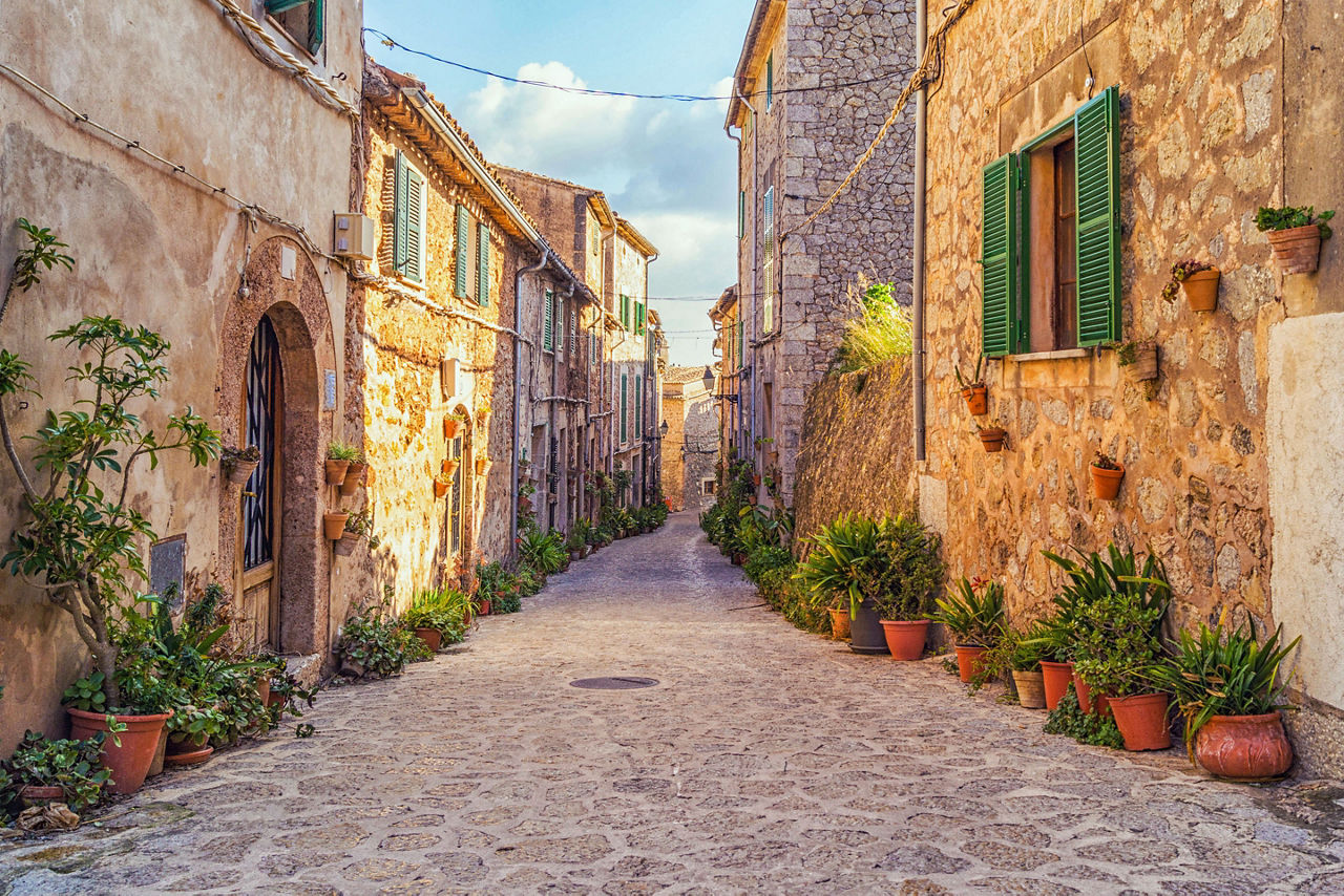 Beautiful courtyard decorated with flower pots and ceramic tiles in Valdemossa, Mallorca, Spain
