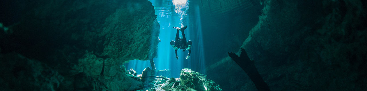Diver diving at Cenote Tajma-Ha, Yucatan, Mexico