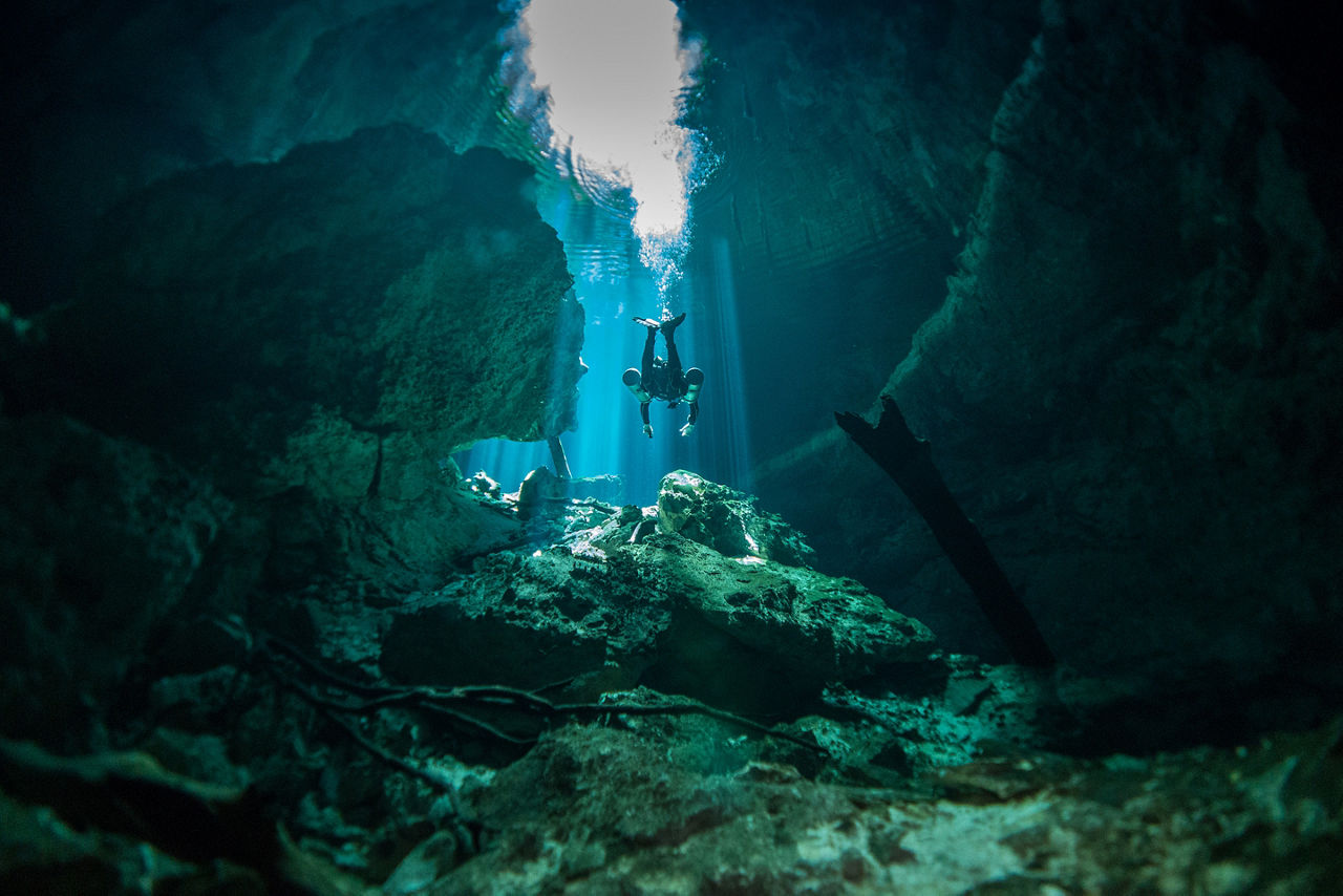 Diver diving at Cenote Tajma-Ha, Yucatan, Mexico