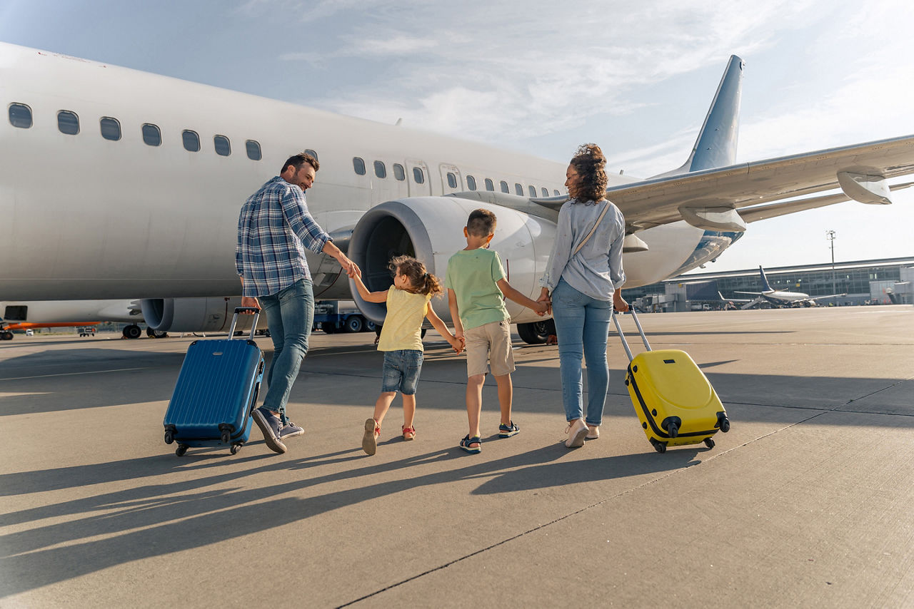 Family with luggage boarding a plane