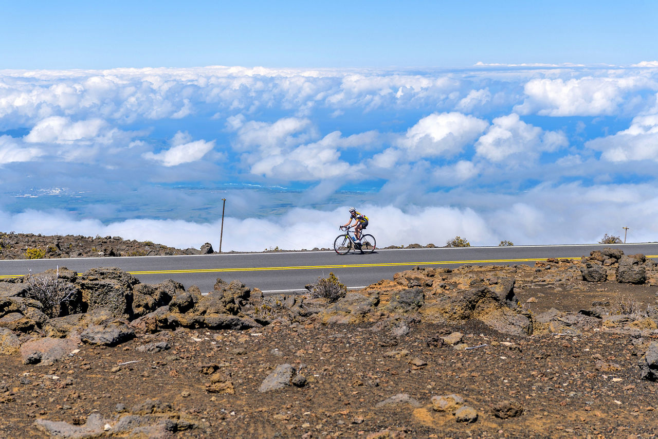 A female bicyclist on Haleakala Highway. Haleakala National Park.